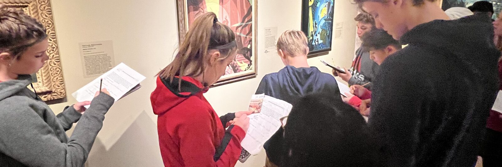 Students view Aaron Douglas paintings at the Milwaukee Art Museum.